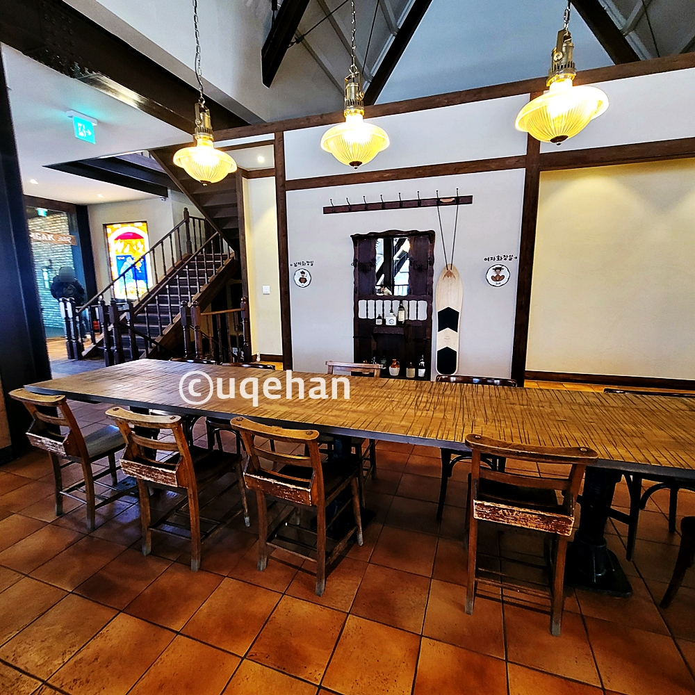 카페 럿지 2층 화장실 앞에서의 사진이다. 그 앞으로 아주 넓은 대형 테이블이 놓여있따.