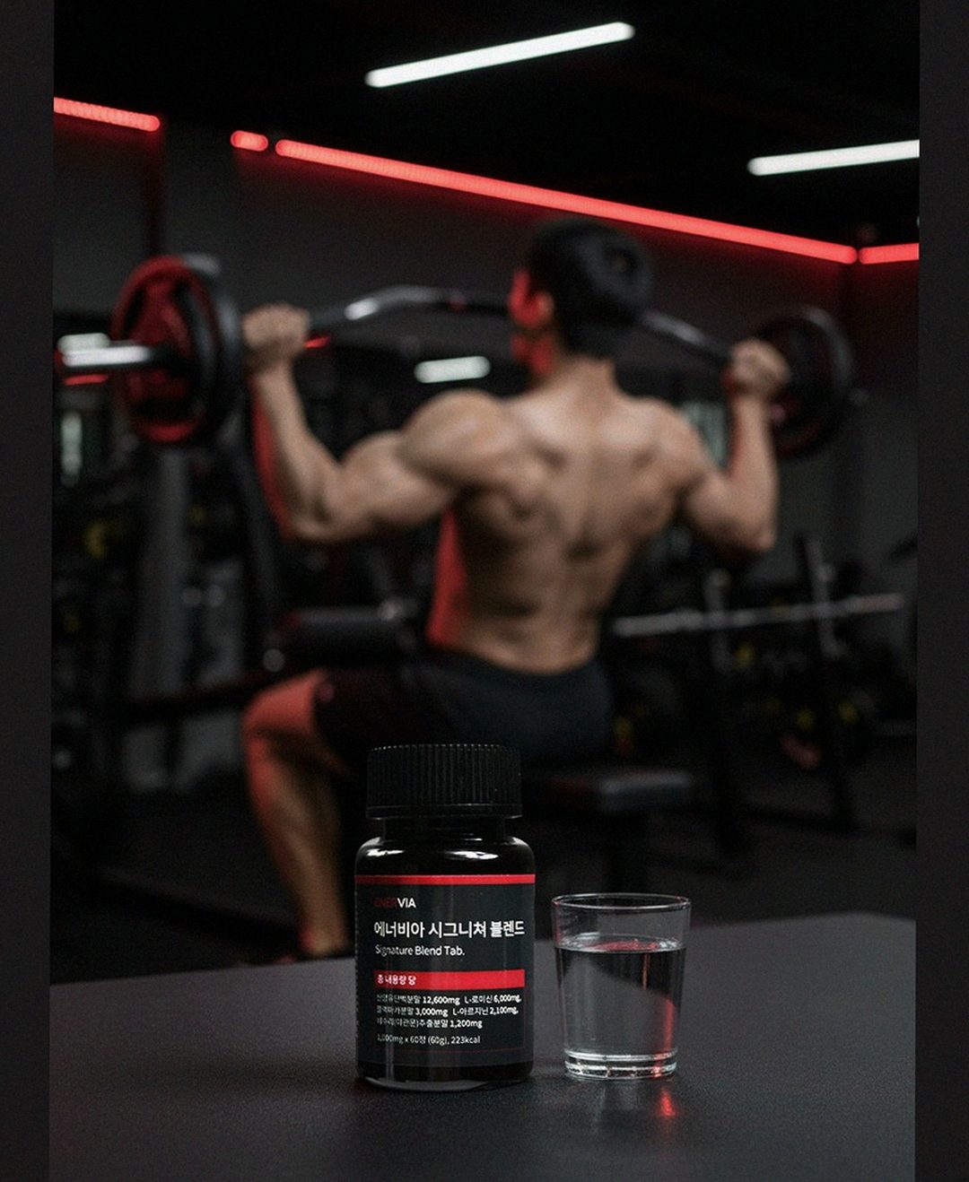 Korean Asian office worker at desk with supplement bottle