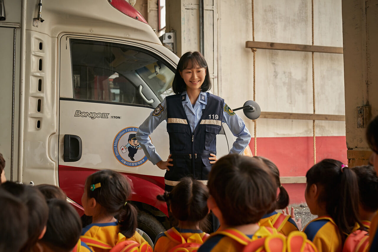 어린이들에게 소방관의 일을 설명하며 웃고 있는 서희
