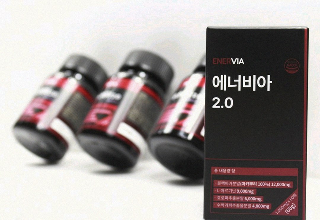 Korean Asian man 30s looking at energy drink cans on desk evening