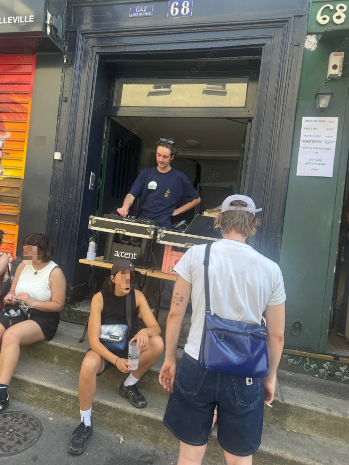 A DJ playing electronic music at a makeshift outdoor booth during Paris street music festival⁠
