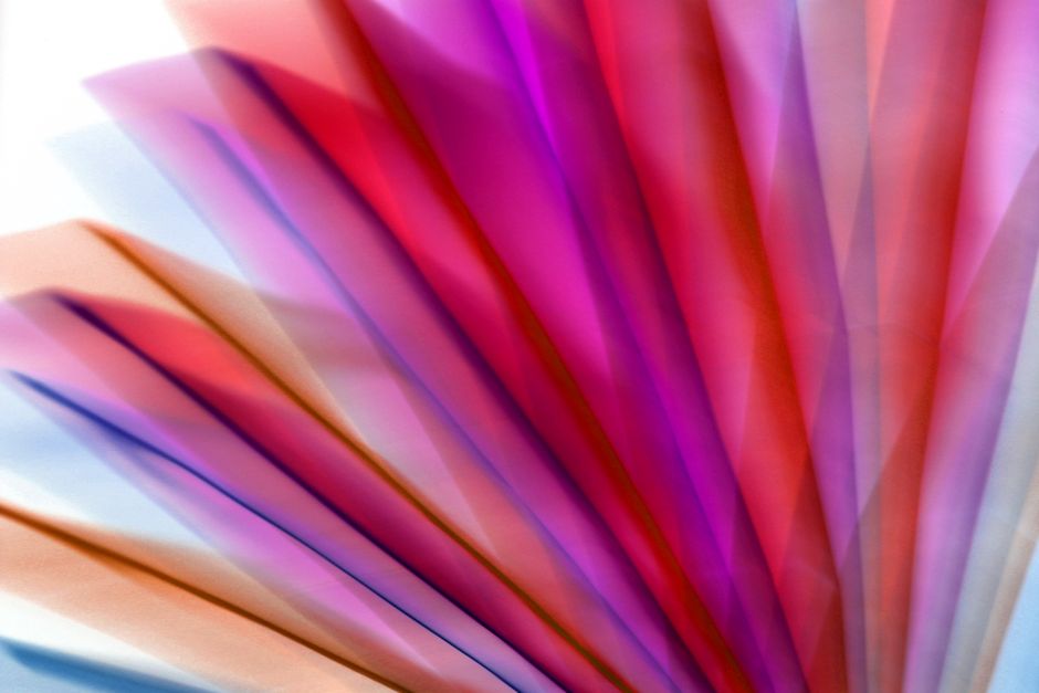 Colorful abstract image featuring overlapping translucent layers with a vivid gradient effect.
