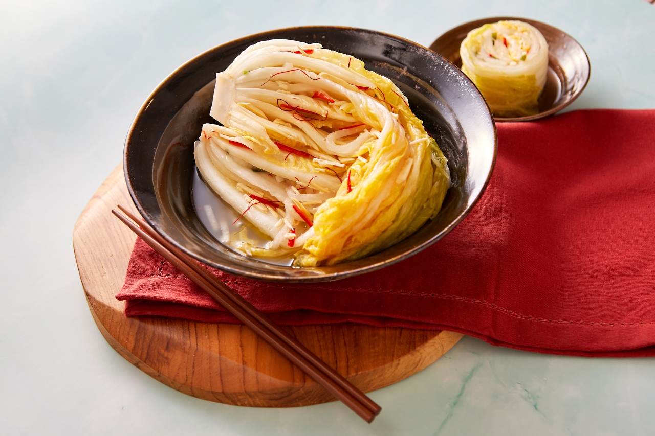 Baek (White) Kimchi in a bowl and a pair of chopsticks