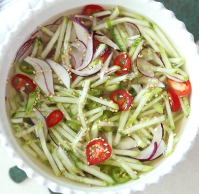 오이, 양파, 붉은 고추를 썰어 넣은 국물요리 오이 냉국. 통깨와 자색 양파를 사용 해서 맛깔 스럽게 보인다.