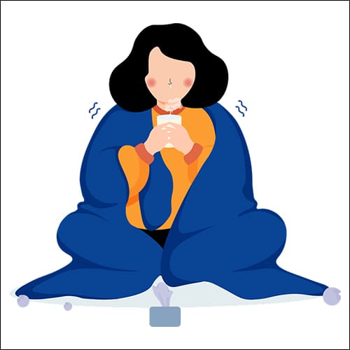 이불을 덮고 오들오들 떨고 있는 여성