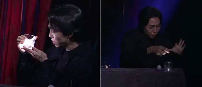 DK 마술사가 빛나는 투명 유리컵을 들고 있다가 테이블에 내려 놓았다.