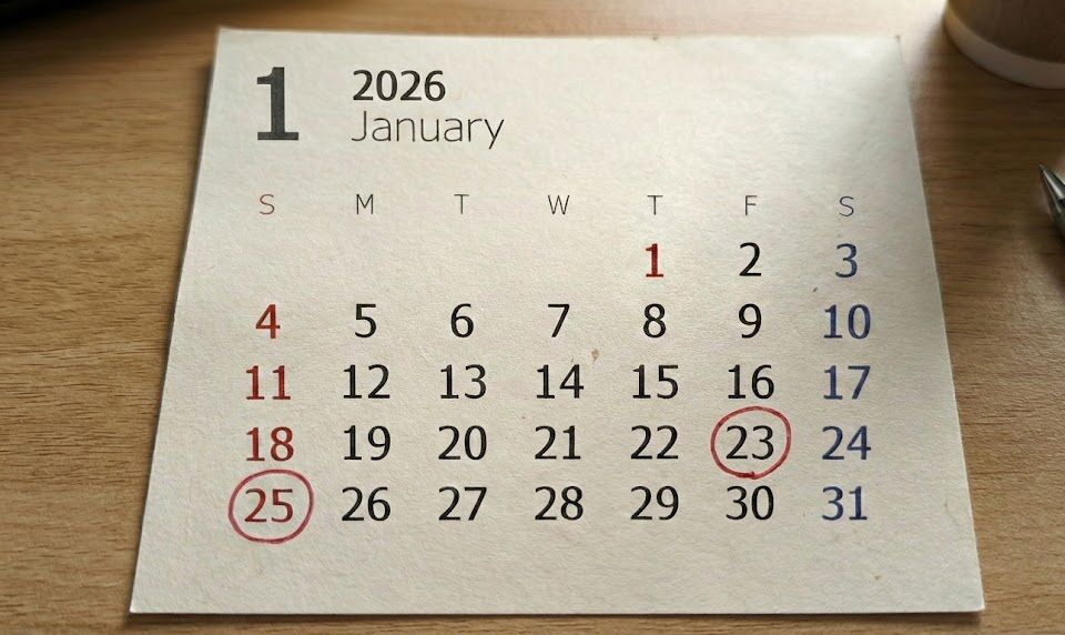 2026년 1월 달력이 책상 위에 놓여 있고, 부모급여 예정일인 25일(일요일)과 실제 지급 예상일인 23일(금요일)에 빨간색 동그라미가 쳐져 있어 지급일 변동을 강조하는 모습