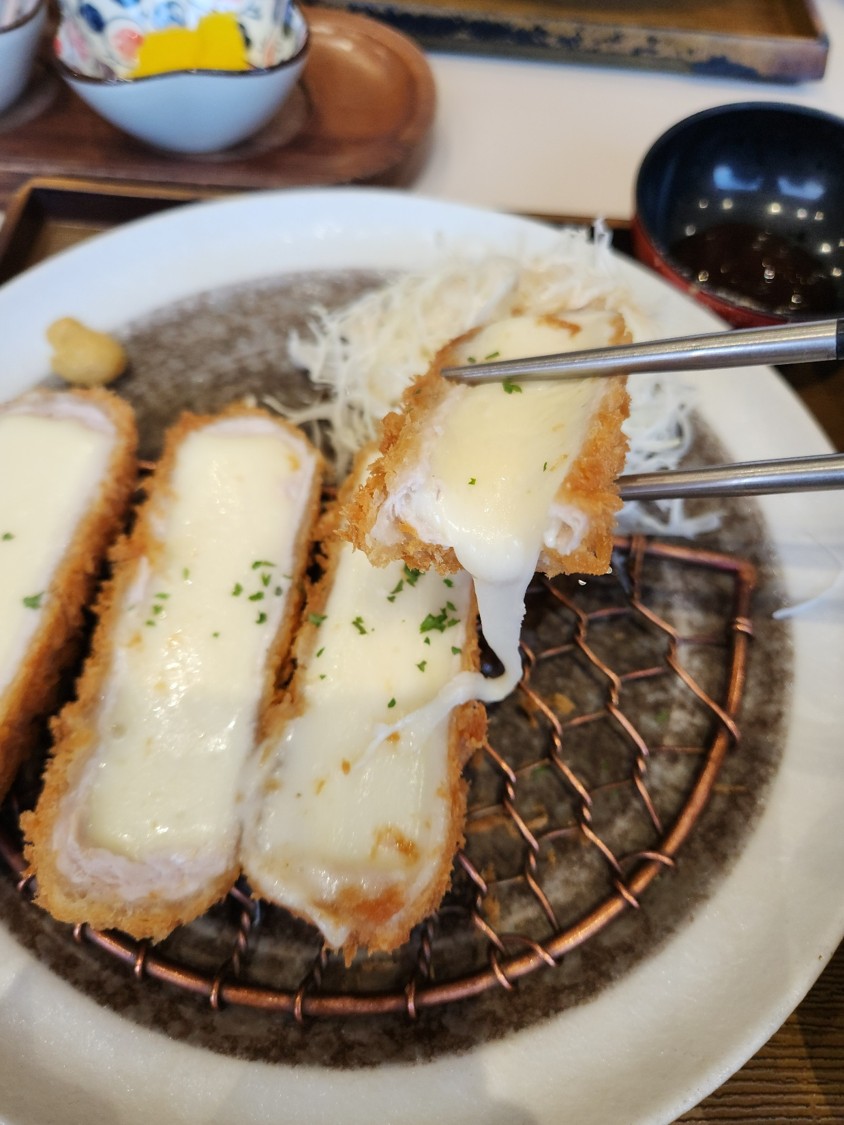 치즈 돈까스의 치즈가 길게 늘어난 모습
