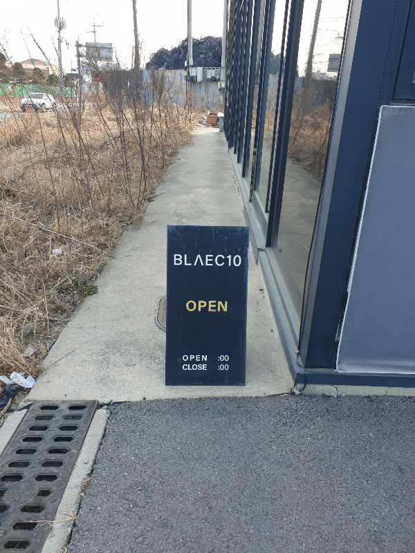 건물 앞에 작은 입간판이 놓여있다. 간판에는 BLAEC10이라고 적혀있다.