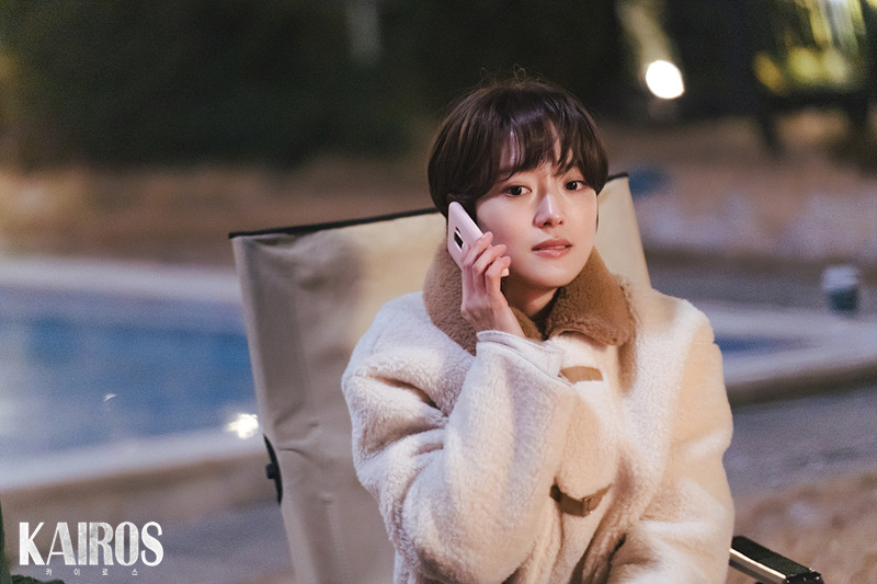밤 야외 의자에 앉아 흰 휴대전화를 귀에 댄 이세영