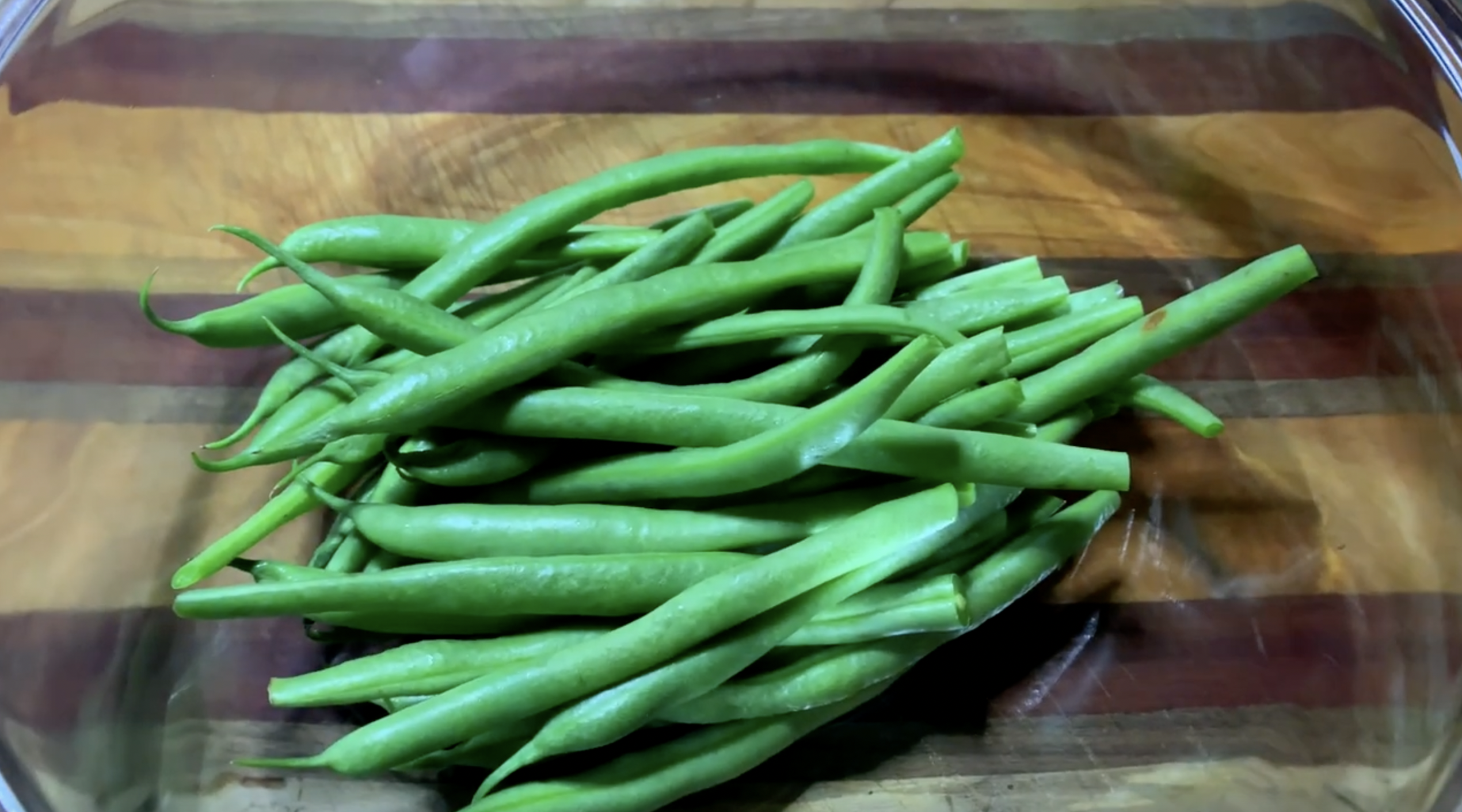 깨끗히 씻은 초록색의 그린빈을 반으로 잘라 볼에 담은 사진