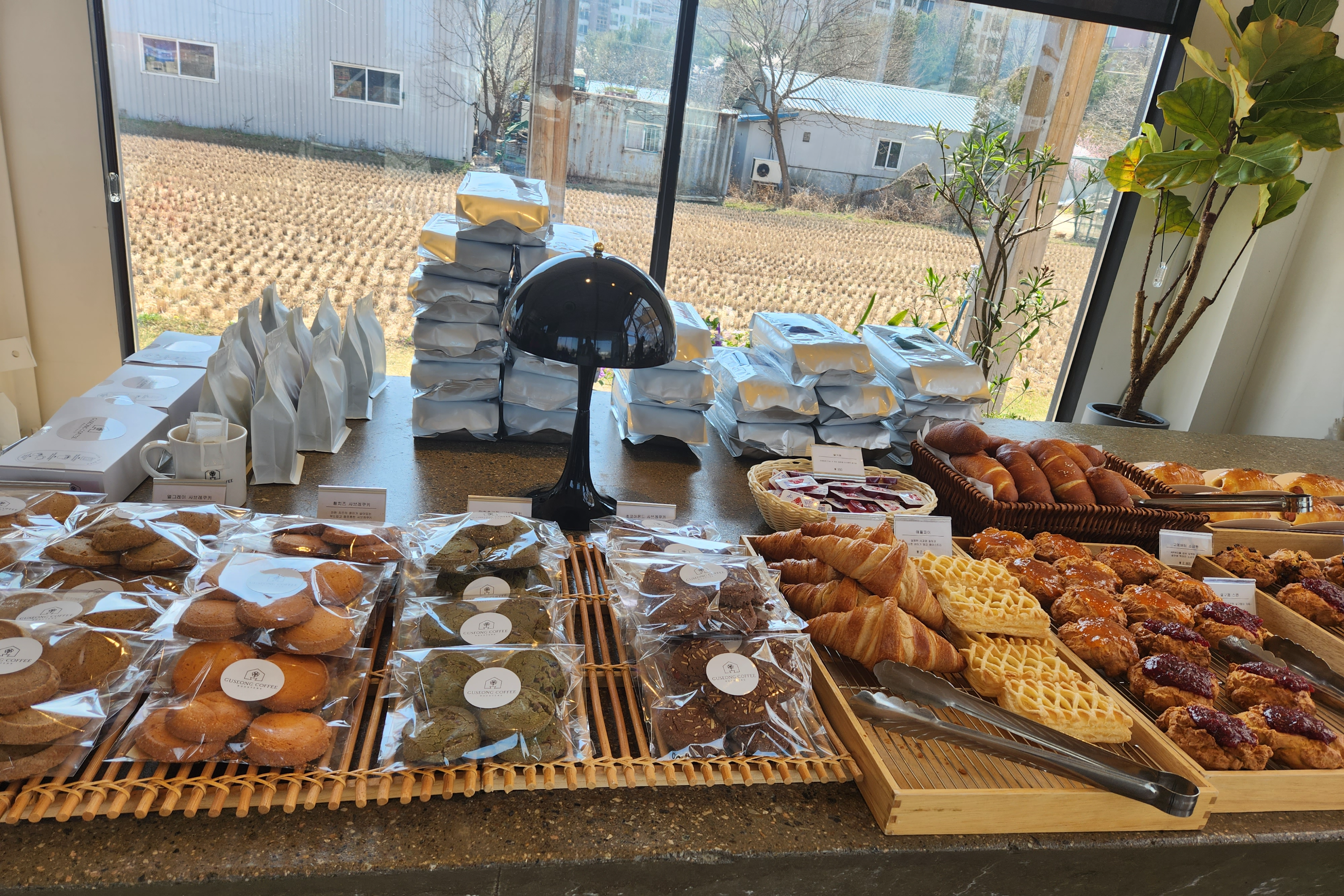 <구성 커피로스터스>의 실내에 들어가니
맛난 베이커리들과 직접 볶은 원두 판매도 하고 있었어요.
창 밖으로는 역시 정감있는 논 풍경이 눈을 사로잡네요.
모내기 계절이 되면 이제 곧 초록초록한 논을 볼 수 있겠어요~