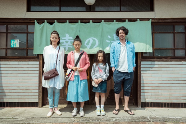 영화 행복 목욕탕의 배경인 '사치노유' 입구에서 후타바와 남편, 두 딸이 함께 모여 가족의 완성을 보여주는 단체 사진