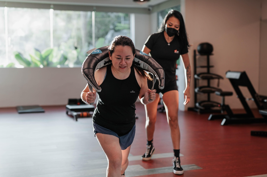 Young Asian Women doing Intense Cardio Exercise, guided by a Female Personal Trainer