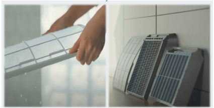 에어컨 필터를 물로 세척한 후 그늘에서 벽면에 기대어 건조하는 모습