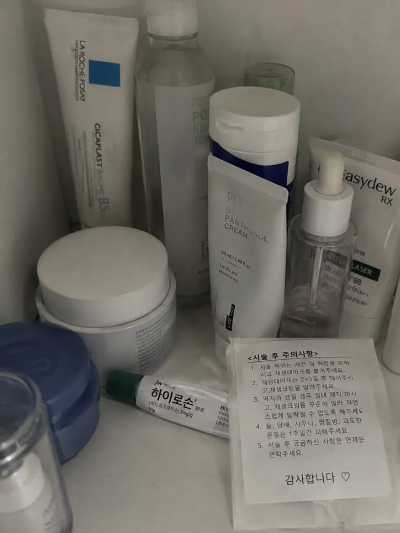 화장대 위에 놓인 판테놀 재생 크림과 라로슈포제 시카밤, 피부과 처방 하이로손 연고 및 시술 후 주의사항 안내문 내돈내산 홈케어 루틴 인증 사진