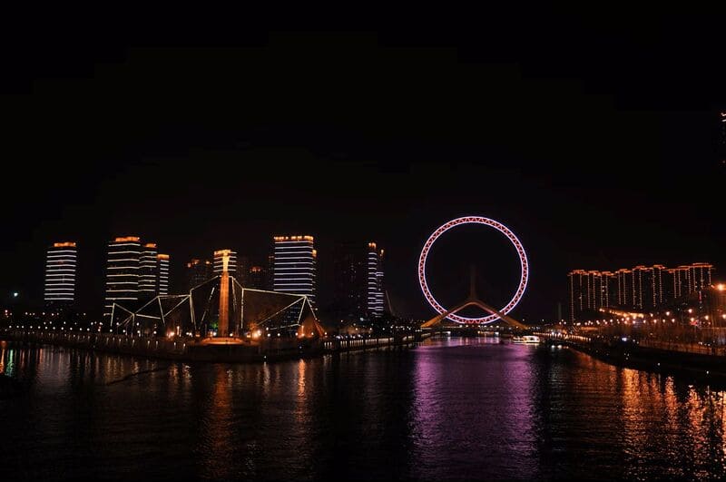 화려하게 조명이 들어온 텐진의 야경과 하천 위에 떠 있는 듯한 대관람차가 도시의 낭만적인 밤을 보여줍니다