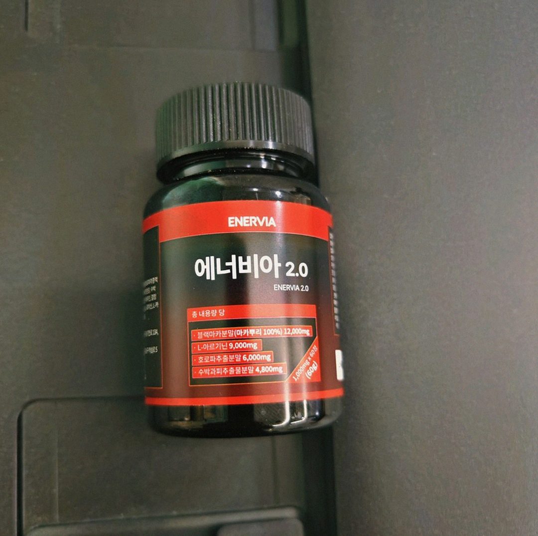 Korean Asian man in 40s comparing workout supplements at home