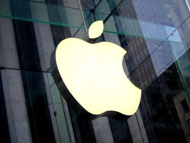 On the glass wall of the building is an apple with a bite&#44; the Apple logo.