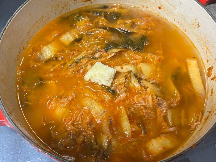 김치&amp;#44; 참치캔&amp;#44; 다진 마늘을 냄비에 넣고 끓이는 사진