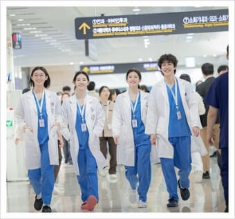 드라마 언젠가는 슬기로울 전공의 생활 사진 주요 출연진들이 의사 가운을 입고 나란히 병원 복도를 힘차게 걸어오고 있다.