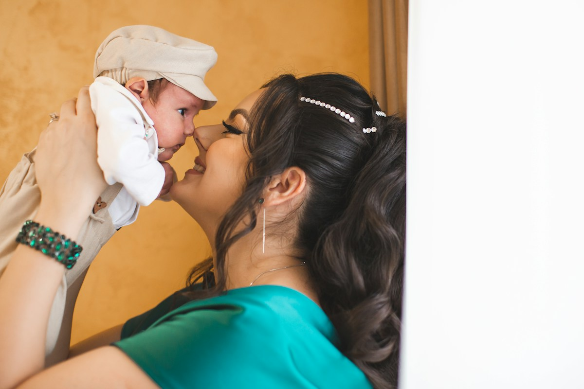 Mother holds her newborn baby near her face