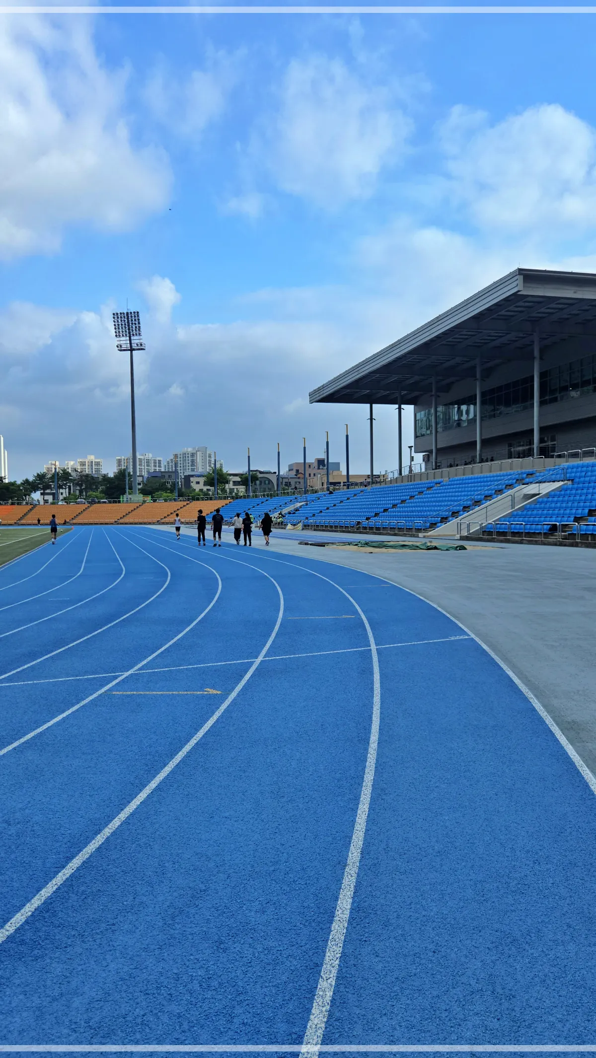 하남종합운동장-육상트랙-달리기하는-사람들과-파란하늘