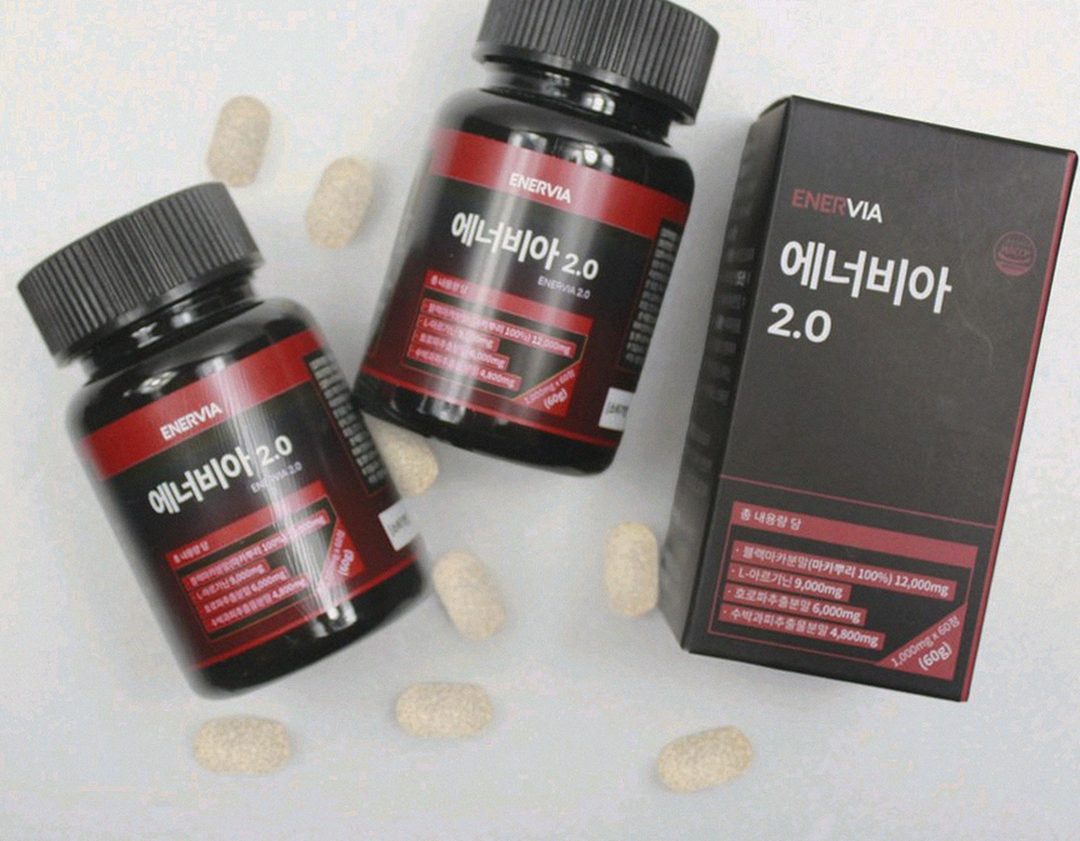 Korean Asian man 37 years old taking supplement after dinner at home kitchen