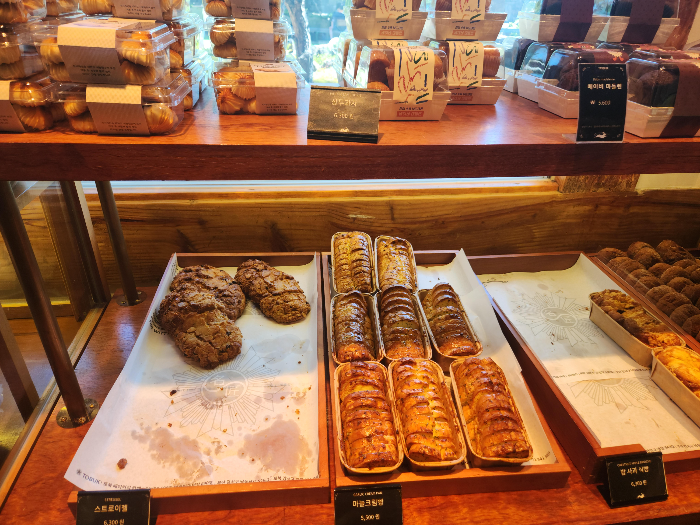 There are pastries, madeleines, and bread on the plate.