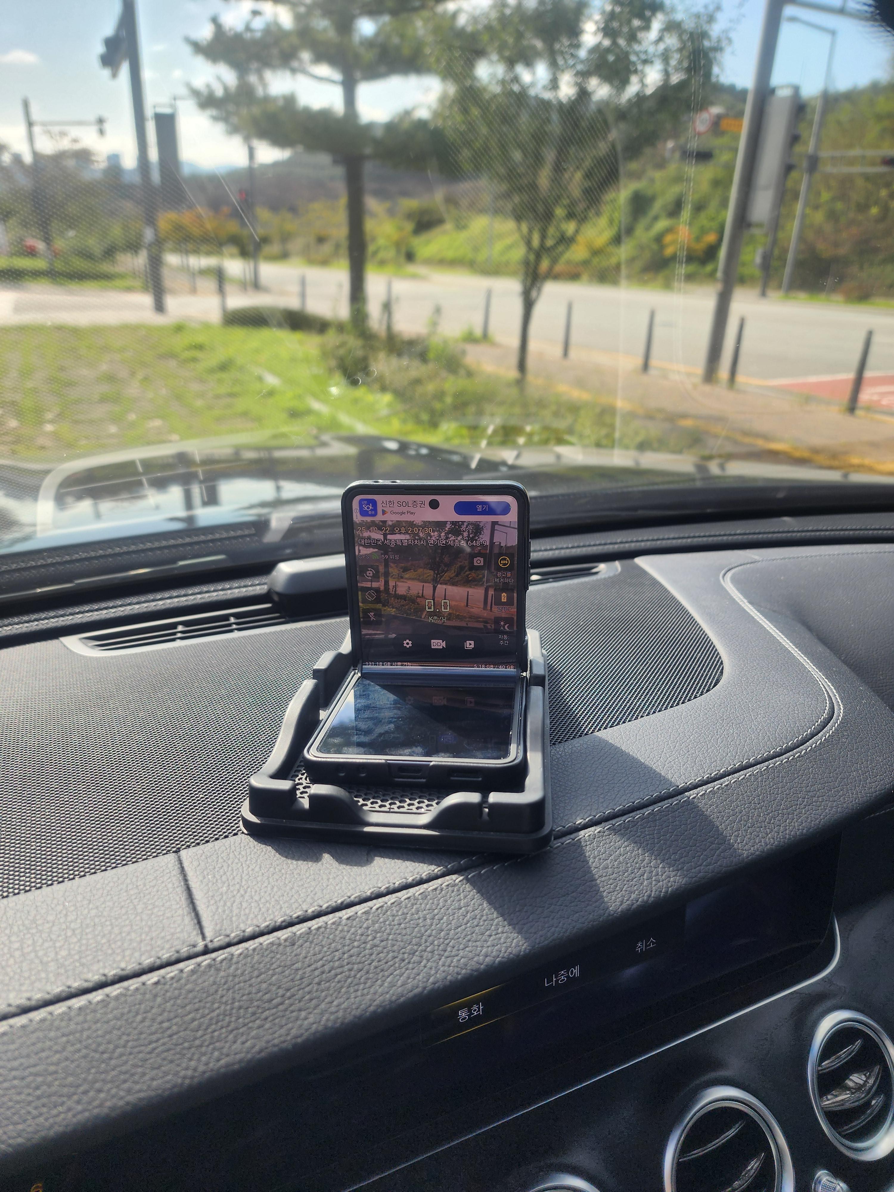 차량 대시보드 위에 세워둔 갤럭시 플립7으로 Droid Dashcam을 실행 중인 모습
