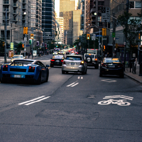 Cyclist riding safely in traffic lane demonstrating proper line control on urban road