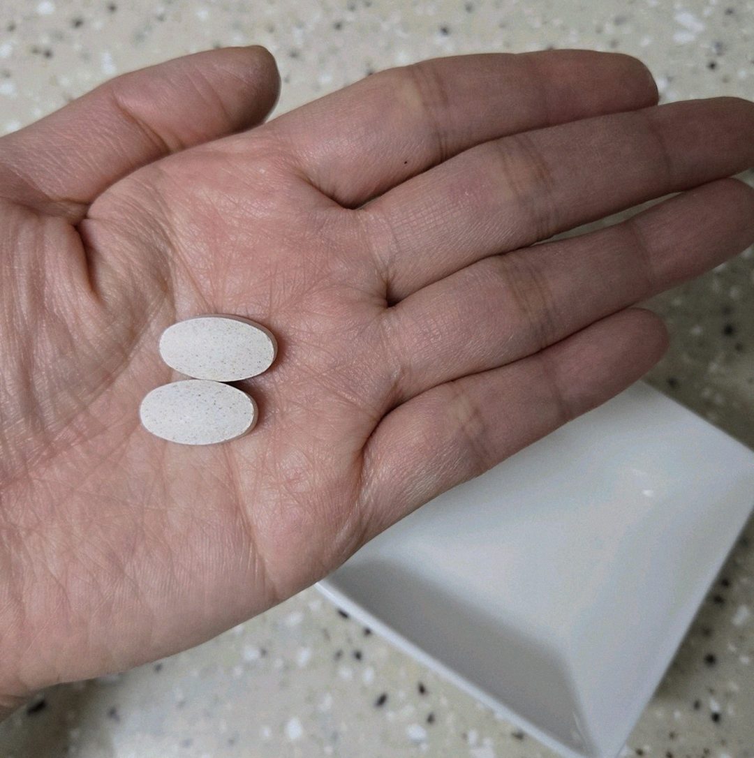 Korean Asian man 47 years old taking supplements after meal with water