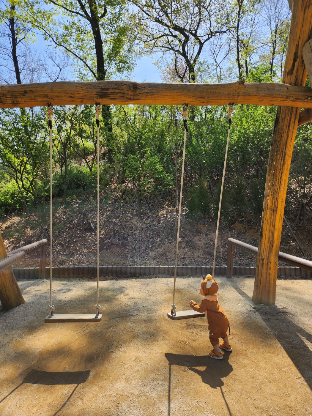 그네를 잡고 서 있는 아이