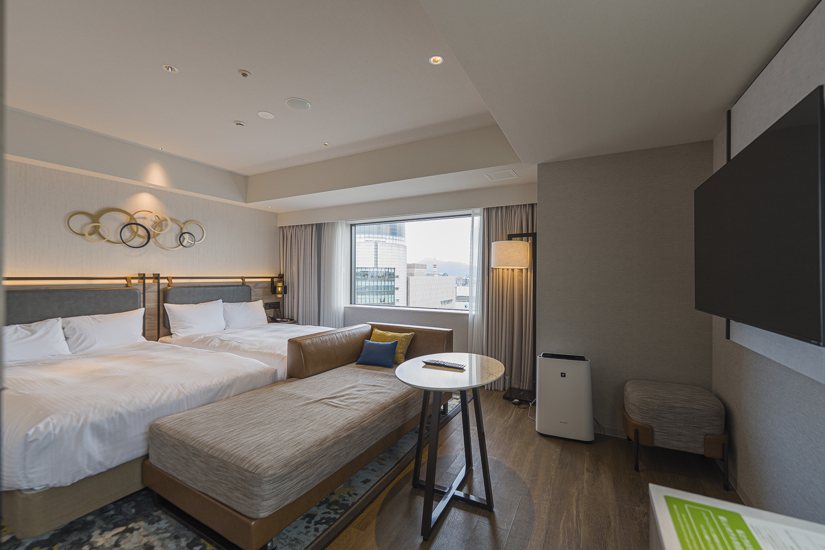 A JR Kyushu Station Hotel Kokura room with two beds and a sofa