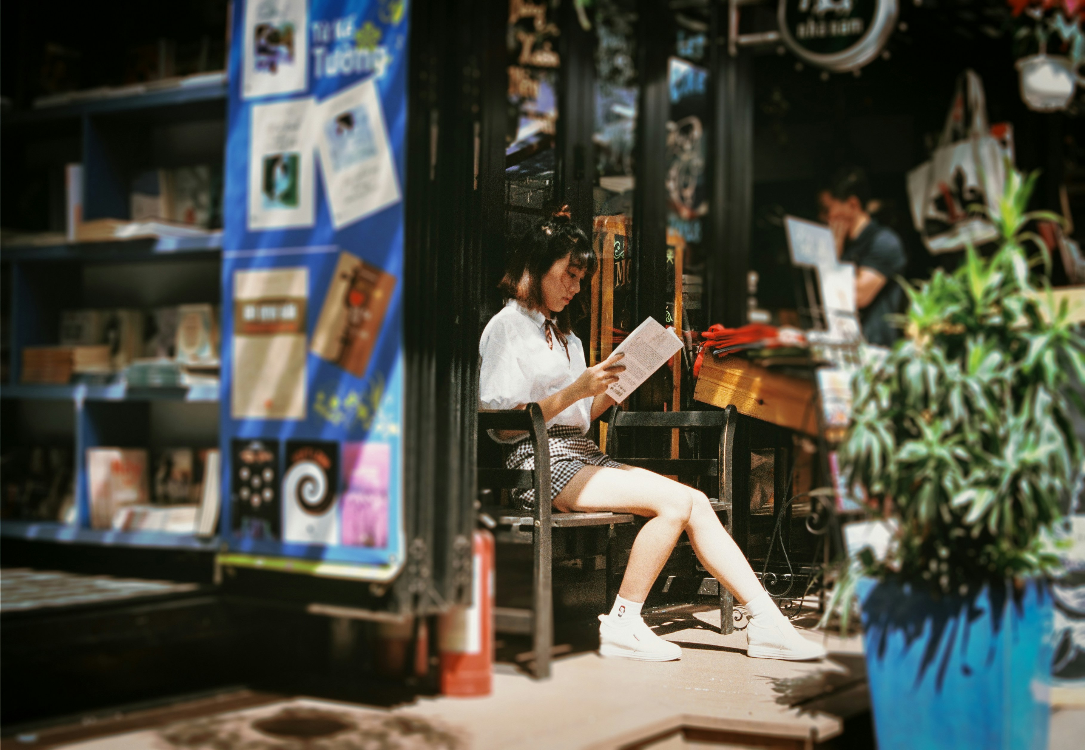 a person reading a book in a cozy cafe