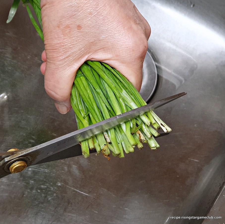 무생채 무침에 들어갈 부추의 뿌리부분을 1cm정도 가위로 잘라주는 사진