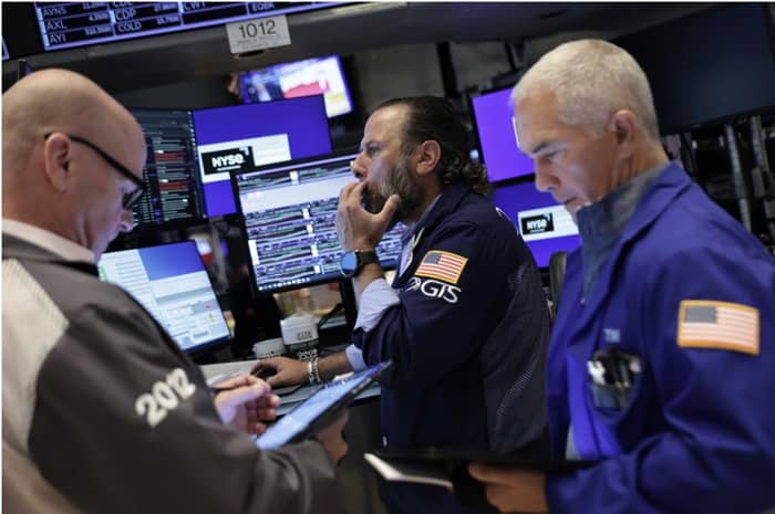 Tuesday’s decline was modest enough to leave all three major indexes in positive territory for the week, so far. Photo: Michael M. Santiago/Getty Images