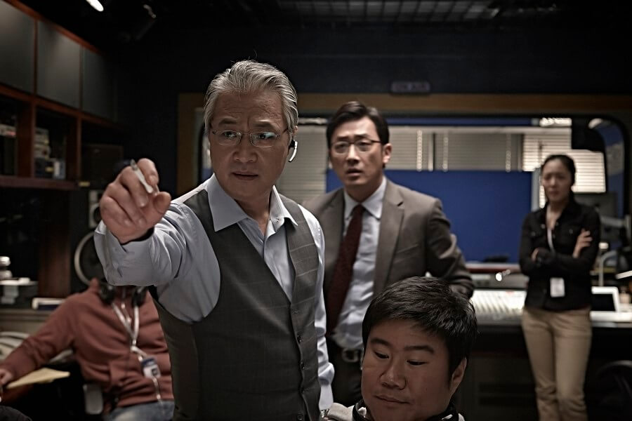 방송국 국장과 그 뒤에 서있는 윤영화