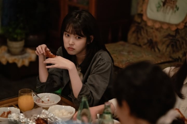 넷플릭스 드라마 폭싹 속았수다에서 아이유가 치킨을 먹으며 대화를 나누는 장면