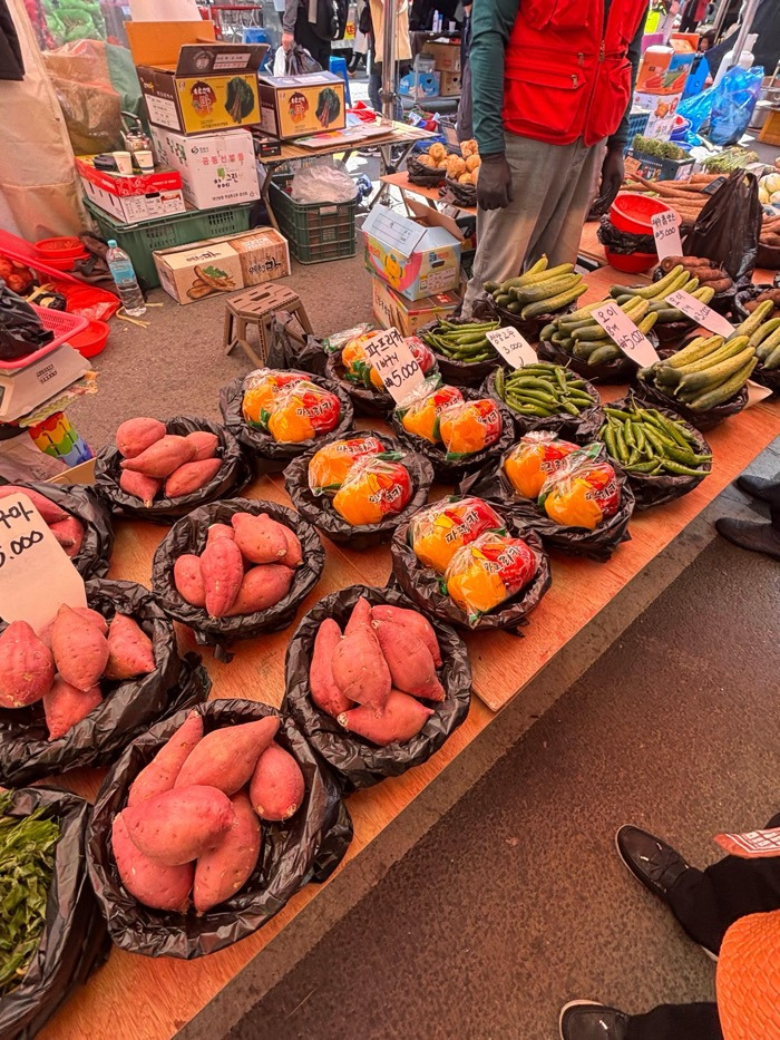 K-market stall with fish, shoes, clothes, and daily goods on display.