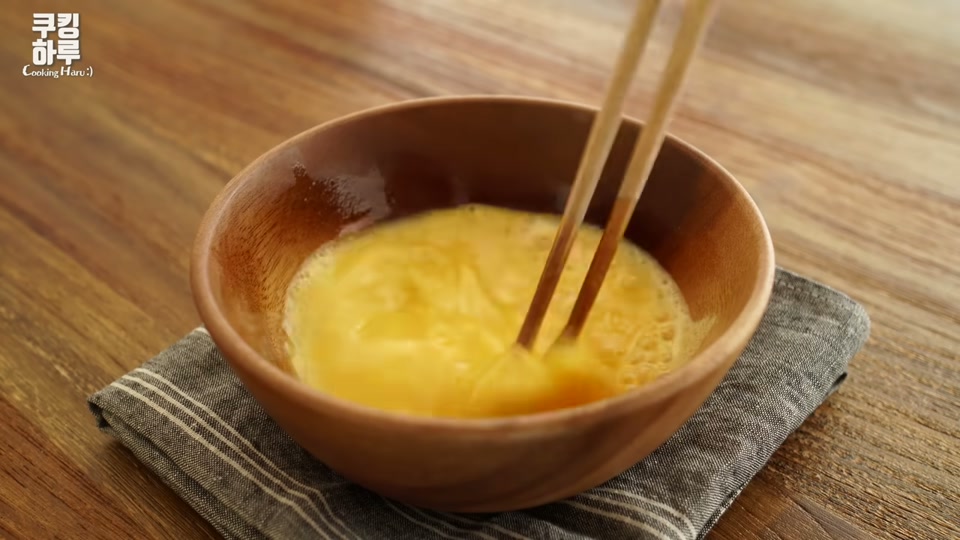 계란물을 젓가락으로 푸는 장면