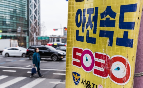 알트태그-도심 거리에 안전속도 5030 홍보 현수막이 걸려 있다