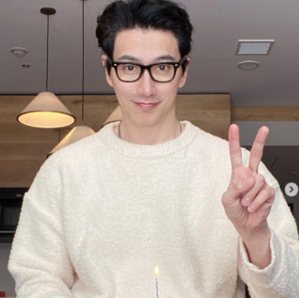 추안도 탄이 손가락으로 브이사인을 하며 포즈를 취하는 모습