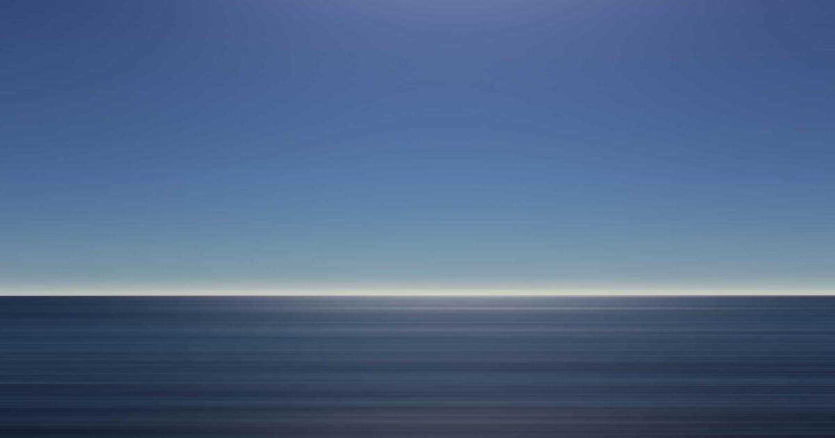 person working on a laptop with graphs and money symbols, a coffee cup on the desk