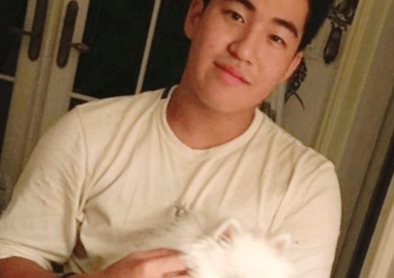 고현정 아들, 정해찬이 흰색 반팔 티셔츠를 입고 강아지를 품에 안고 있는 따뜻한 실내 사진