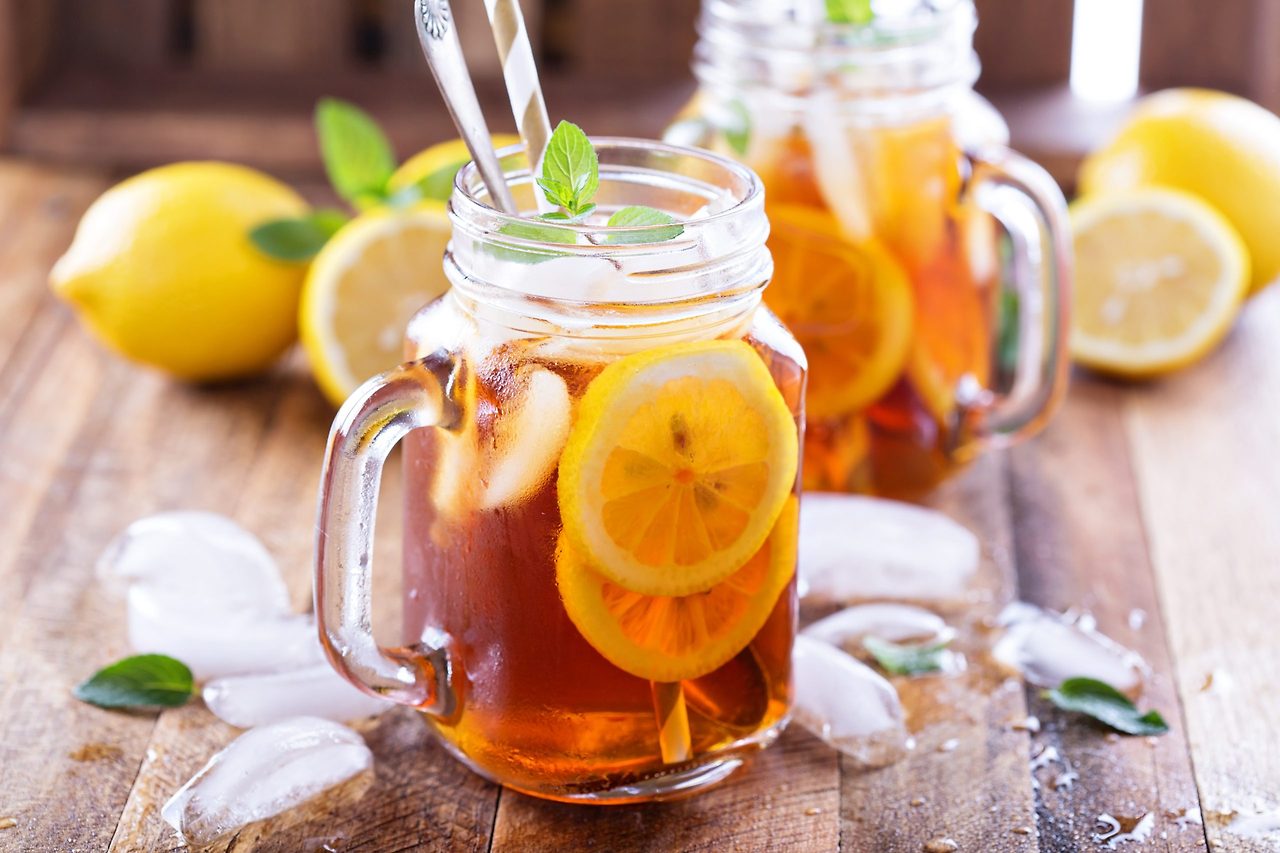 A variety of healthy summer drinks made with purified water, including lemon mint water, cucumber ginger smoothie, grapefruit herb tea, blueberry yogurt drink, and