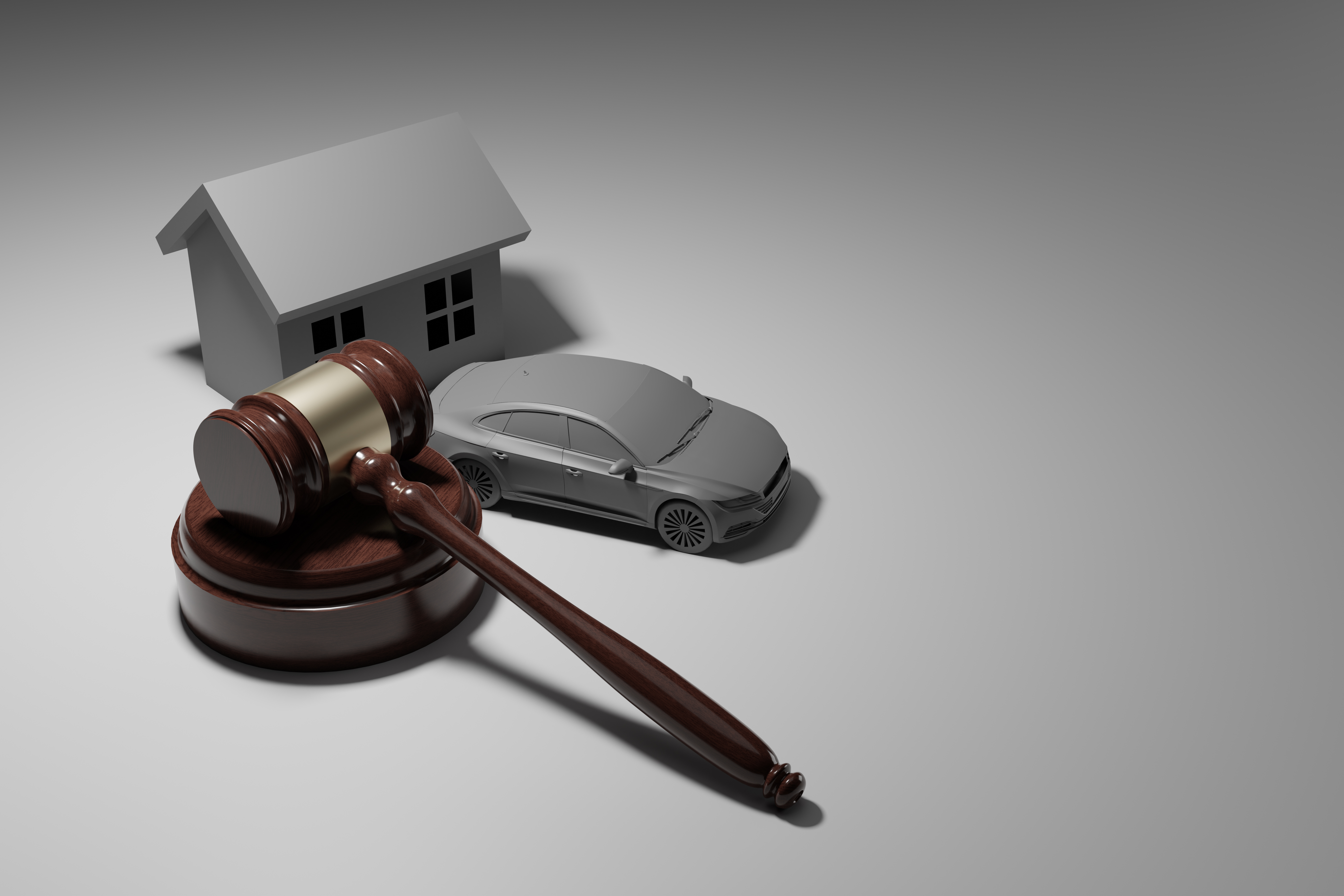 이혼 재산분할에서 주택과 자동차 같은 재산을 법적 판결로 나누는 것을 상징하는 법봉 이미지