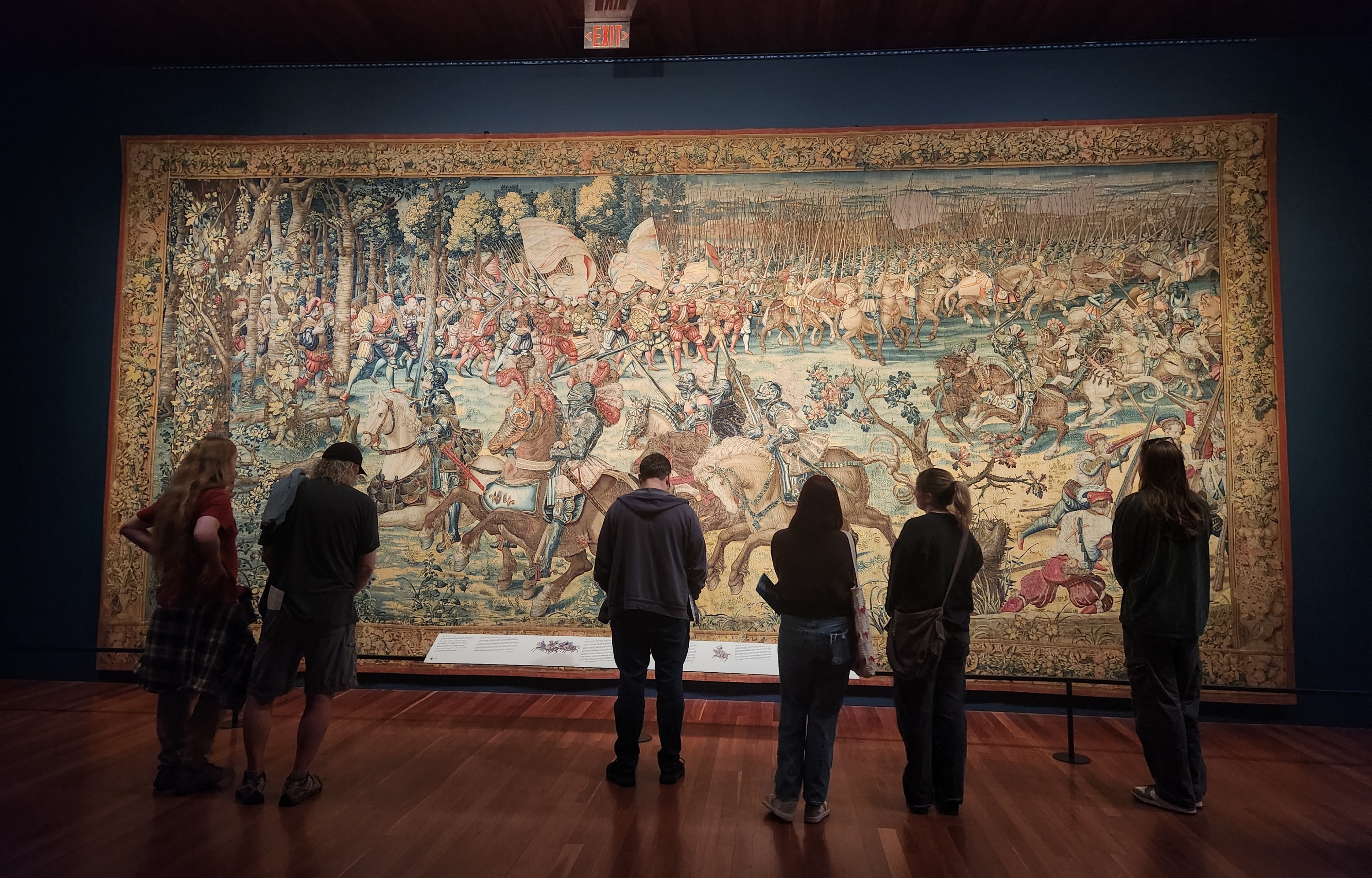 대규모의 전투를 보여주는 그림이 그려진 카펫을 보여주는 이미지