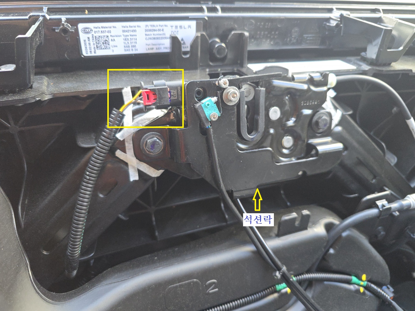 Marking the original frunk latch position with masking tape for Tesla DIY