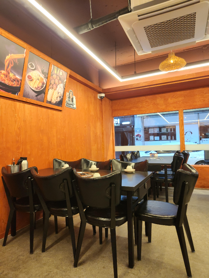Tables and chairs are arranged inside the store.